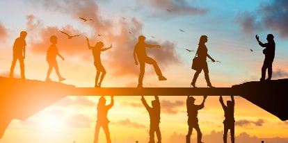 A group of people standing on top of a hill.